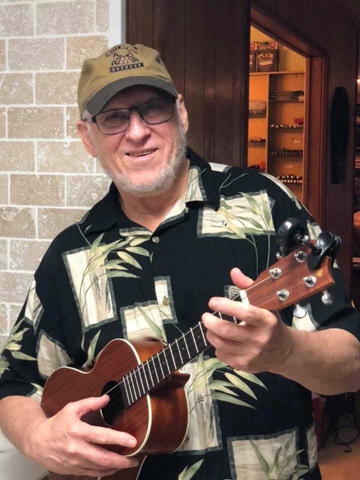 Harvey playing a ukulele. 